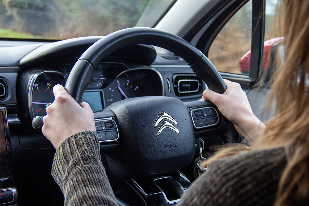 Student holding the steering wheel and driving