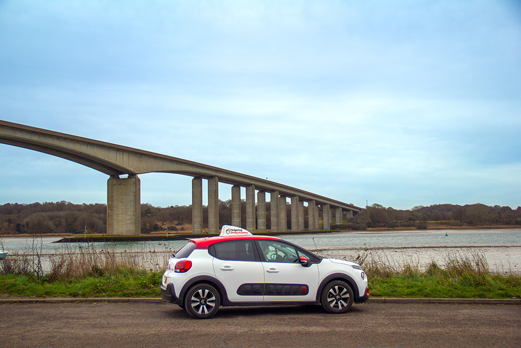 Hedgehog Driving Academy car in front of the Orwell Bridge in Ipswich